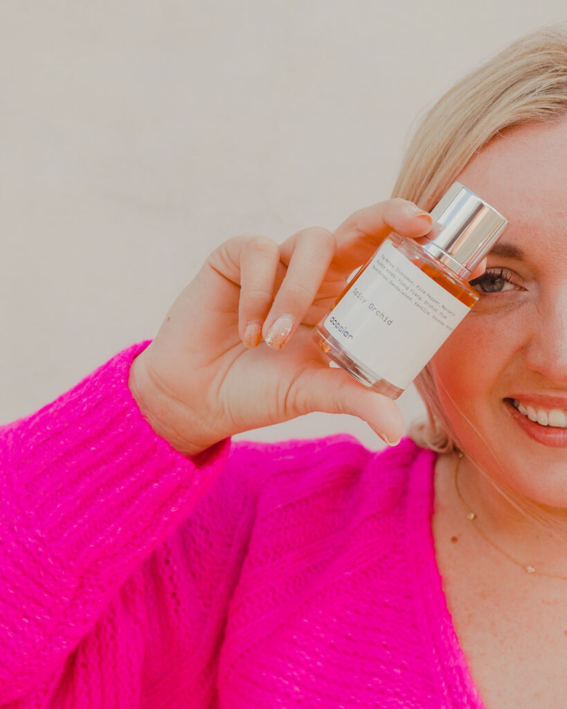 Gift Ideas for Valentine's Day - Woman holding bottle of perfume from Dossier