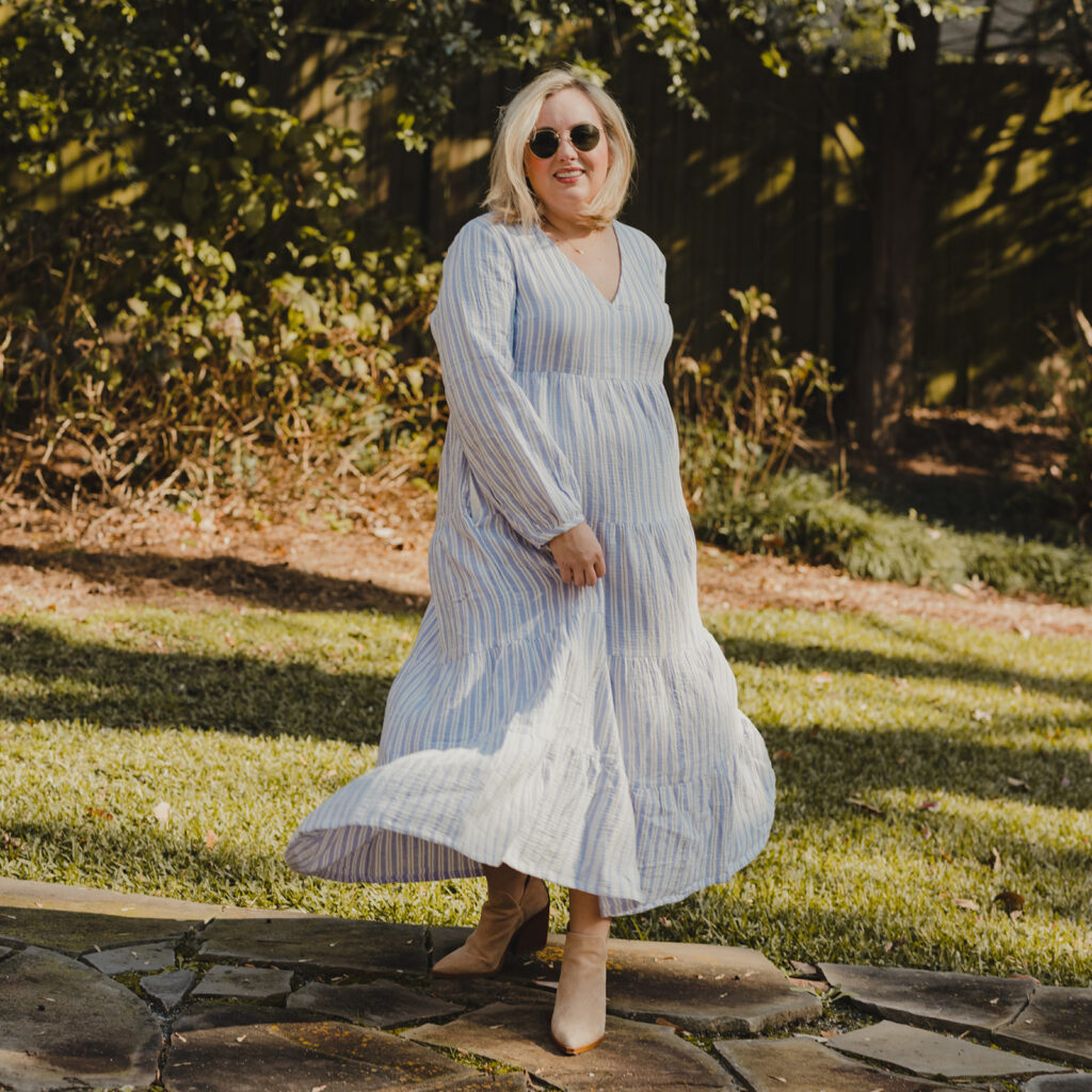 Spring Dresses from Target - Woman standing outside twirling in a long sleeve v neck tiered maxi dress, wearing sunglasses