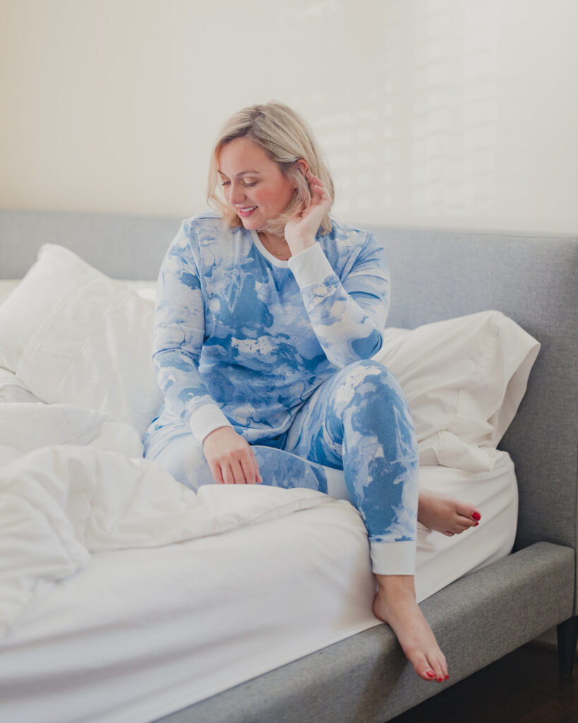 Spring Target Finds - Woman sitting on bed wearing long sleeve blue tie dye matching set. 