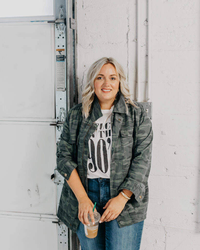 Woman wearing Camo Jacket, Graphic Tee and Denim Jeans