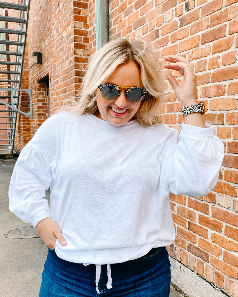 Woman wearing white long sleeve top and Denim Jeans from Banana Republic. SellEatLove.com