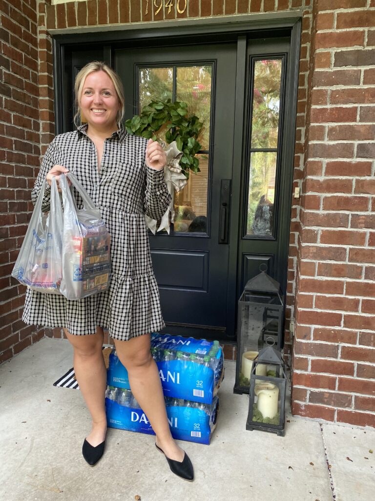 Why I got a Walmart+ Membership. Woman standing on front porch with Walmart + Delivery. SellEatLove.com