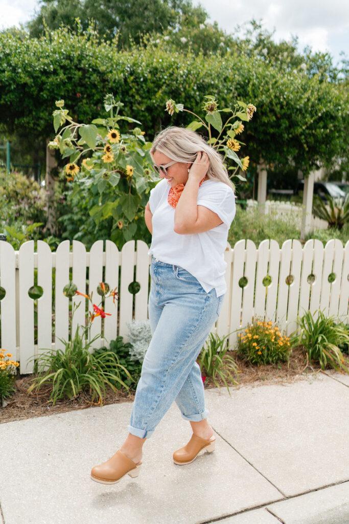 5 Trends to Try This Fall | Sell Eat Love - Woman wearing white dolman sleeve tee, boyfriend denim jeans and clogs. 